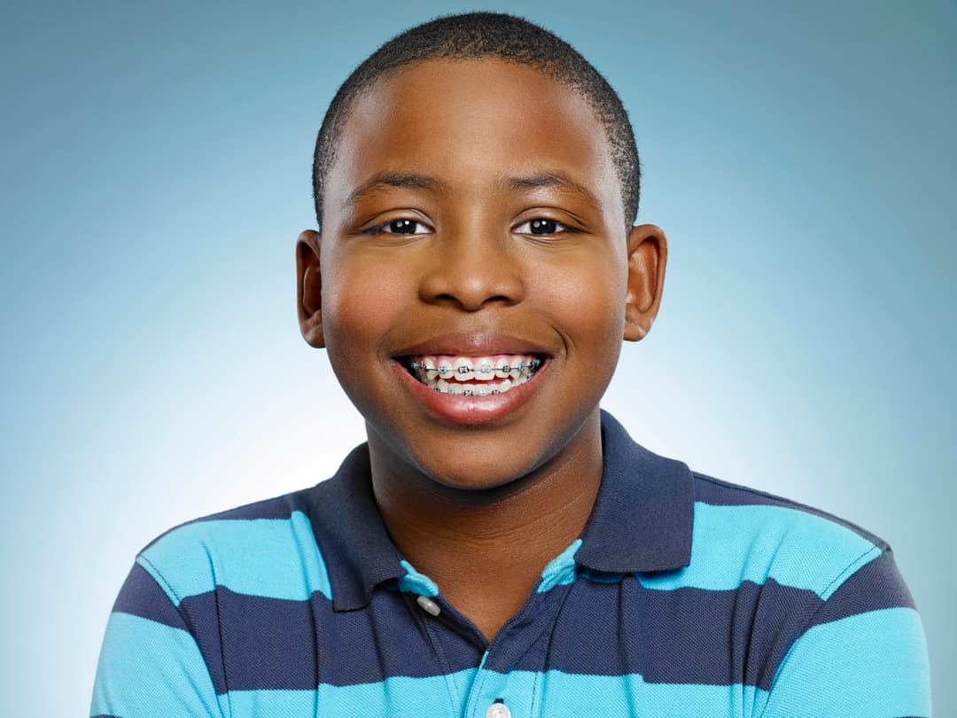 boy smiles with braces